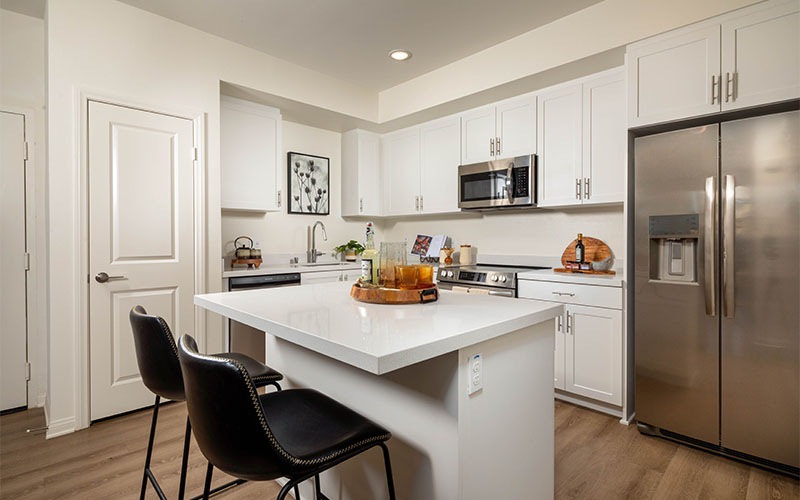 a kitchen with white counter tops